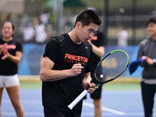 Albert, tennis racket stringer in San Francisco, on court holding a racket